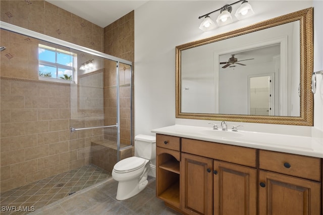 bathroom featuring tile patterned floors, toilet, vanity, and walk in shower