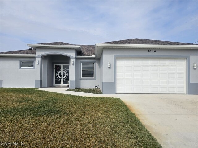 view of front of property with a garage and a front yard