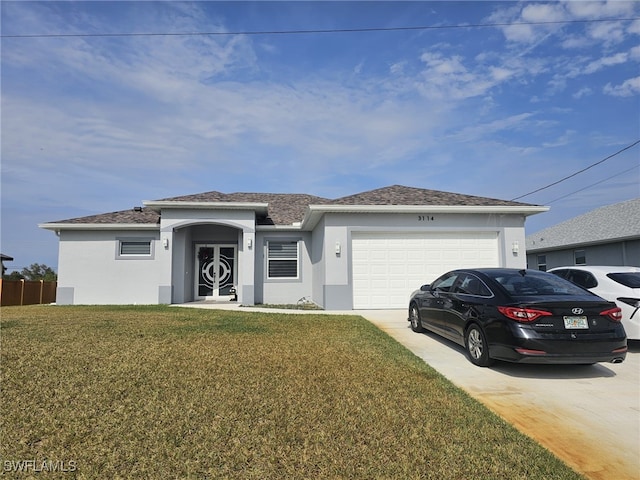 view of front of house with a garage and a front yard