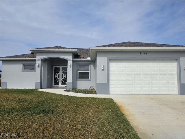 view of front of property featuring a front yard and a garage