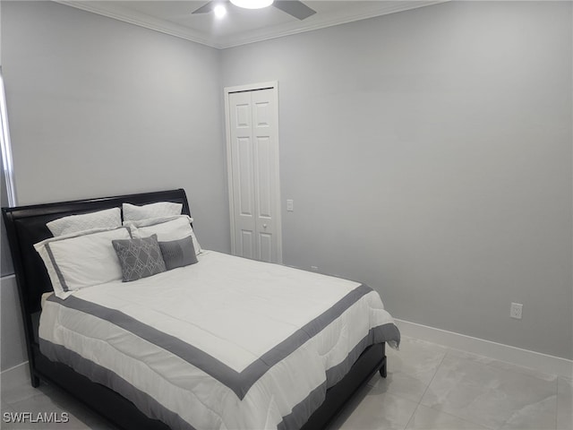 tiled bedroom with ceiling fan, ornamental molding, and a closet