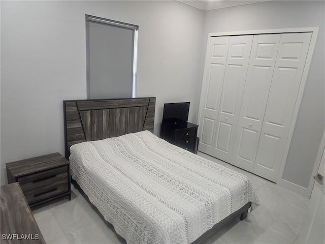 bedroom featuring a closet and ornamental molding