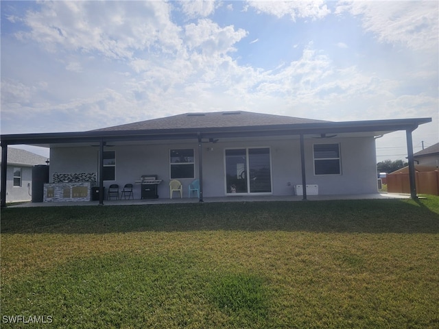 back of property featuring a yard and a patio