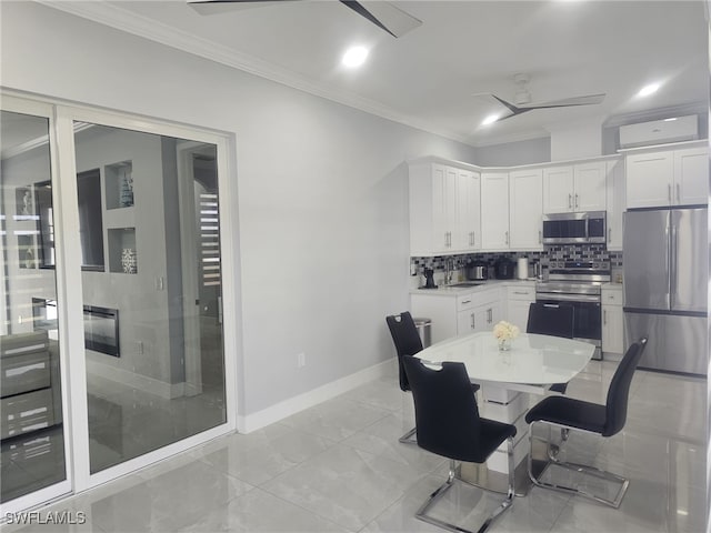 dining space with ceiling fan and crown molding