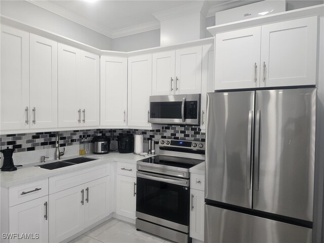 kitchen with sink, ornamental molding, stainless steel appliances, and white cabinetry