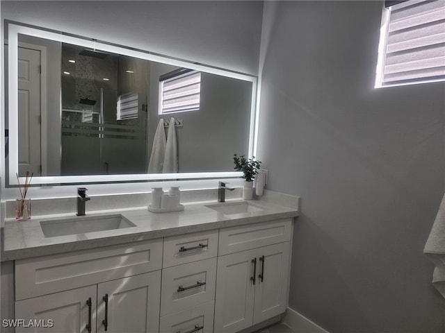 bathroom with a shower with door and vanity