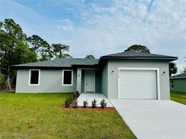 ranch-style house featuring a front lawn and a garage