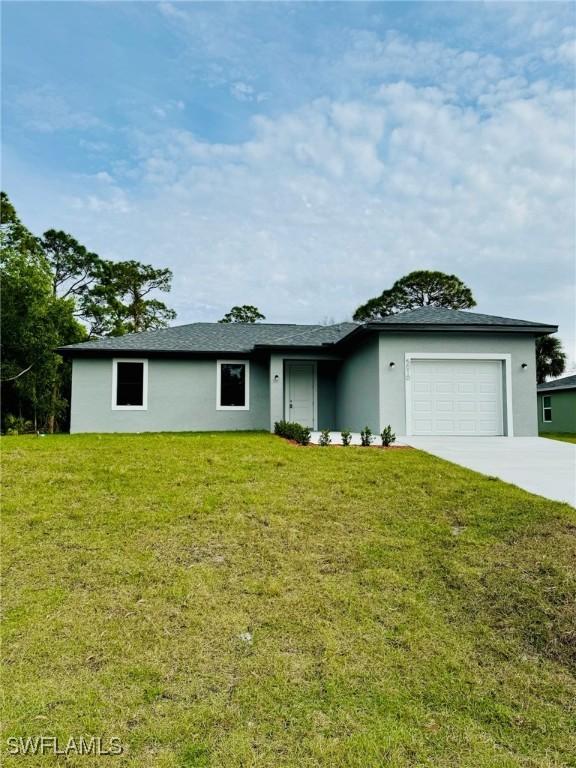 ranch-style home with a garage and a front lawn