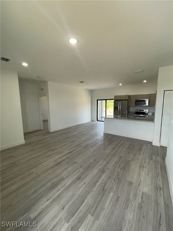 unfurnished living room with light hardwood / wood-style flooring