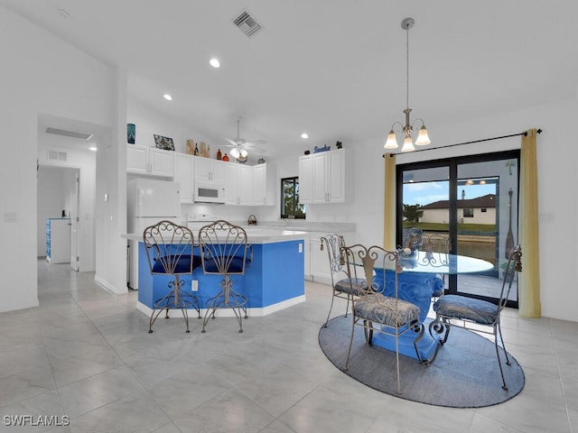 dining room with lofted ceiling and ceiling fan with notable chandelier