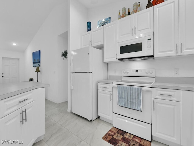 kitchen with white cabinetry, lofted ceiling, and white appliances