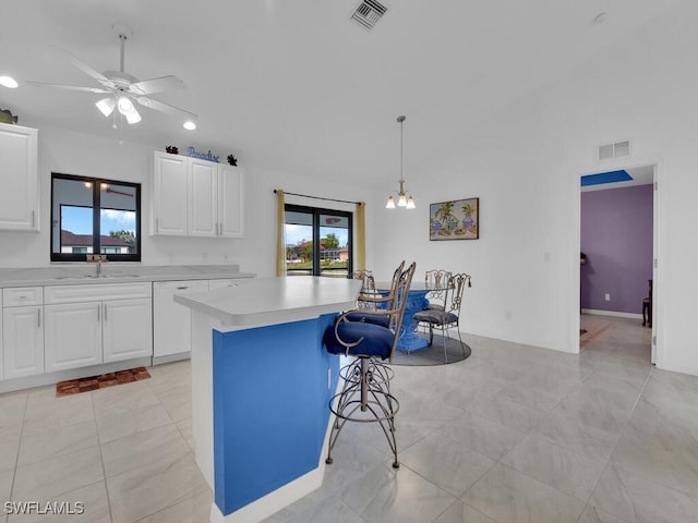 kitchen featuring a kitchen island, white cabinetry, dishwasher, sink, and hanging light fixtures