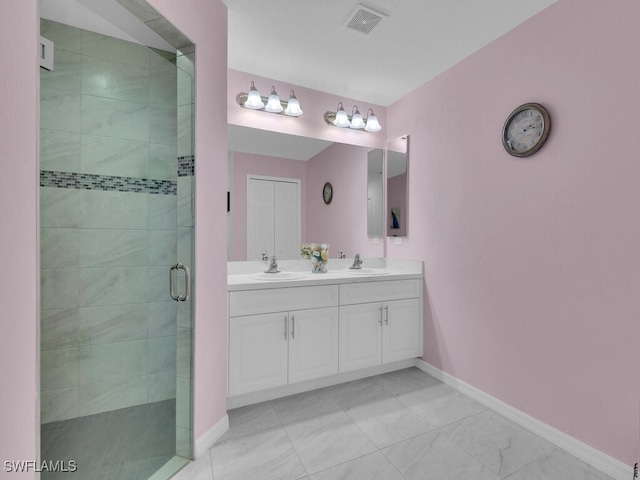 bathroom featuring vanity and a shower with door