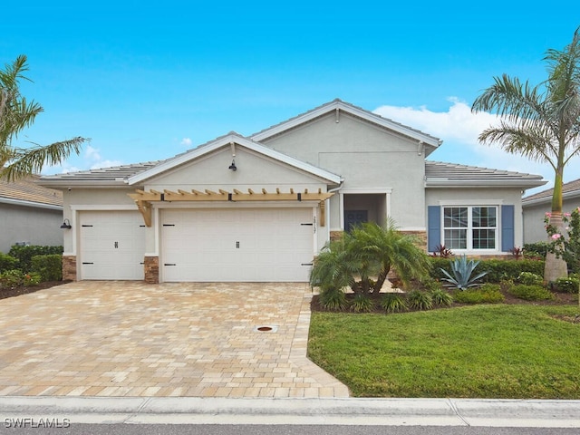 single story home featuring a garage and a front yard