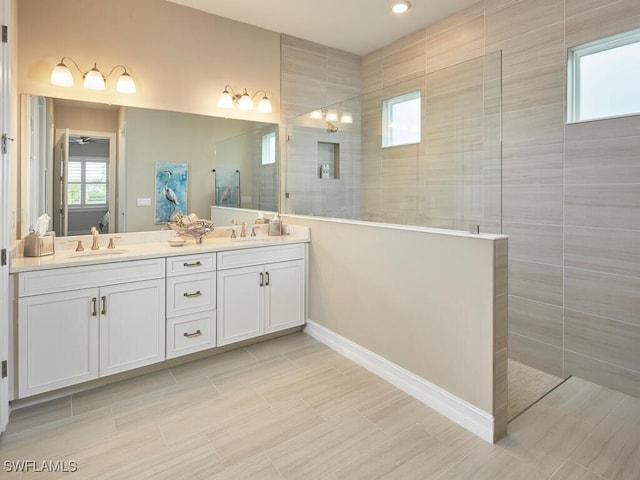 bathroom with vanity and a tile shower