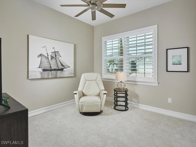 living area with carpet floors and ceiling fan