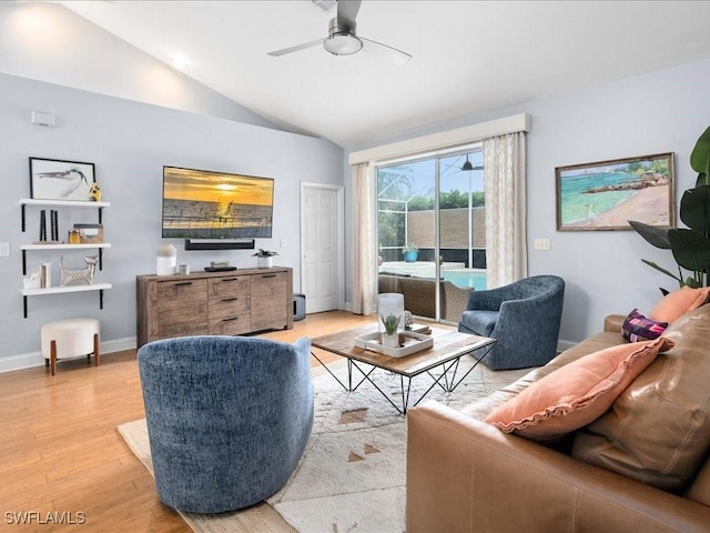 living room featuring vaulted ceiling, ceiling fan, and light wood-type flooring