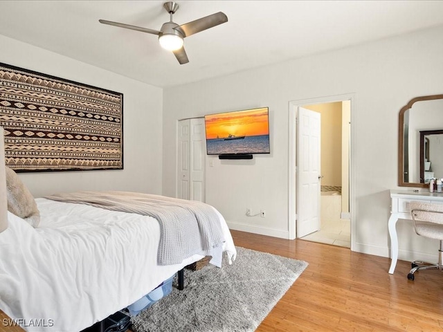 bedroom with ceiling fan, a closet, connected bathroom, and light hardwood / wood-style flooring