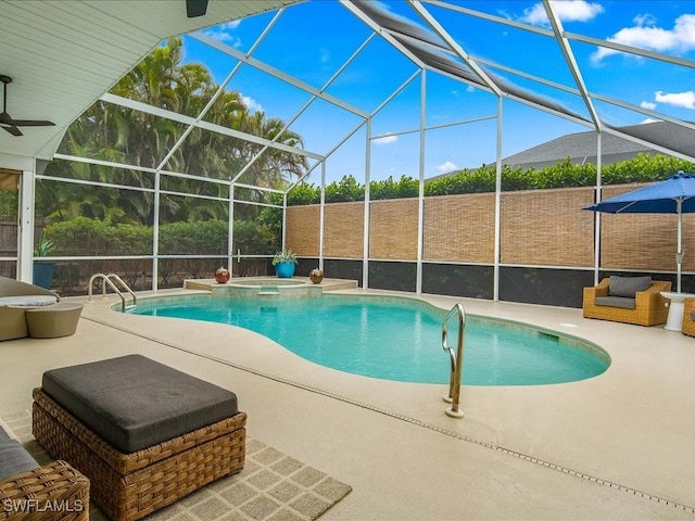 view of pool with a lanai, ceiling fan, and a patio area