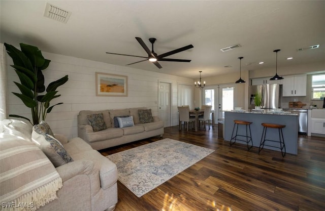 living room featuring ceiling fan, french doors, and dark hardwood / wood-style flooring