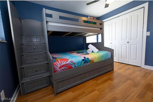 bedroom with ceiling fan, a closet, and light hardwood / wood-style flooring