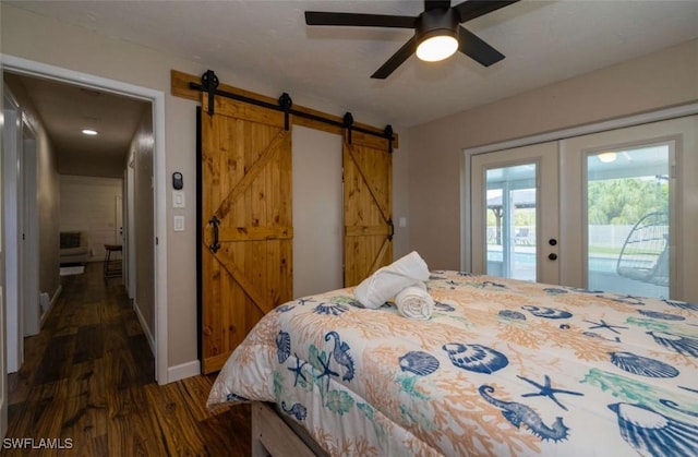 bedroom with french doors, access to exterior, dark hardwood / wood-style floors, ceiling fan, and a barn door