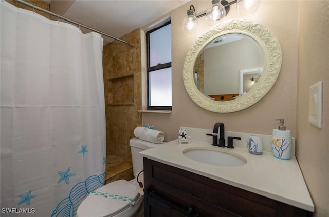 bathroom with toilet, vanity, and a shower with shower curtain