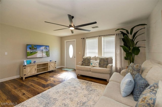 living room featuring ceiling fan and dark hardwood / wood-style floors