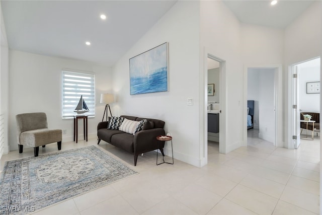 living room featuring high vaulted ceiling and light tile patterned flooring