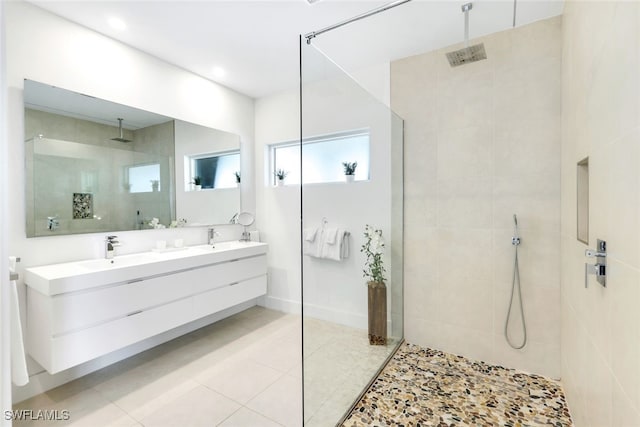 bathroom featuring a tile shower and vanity