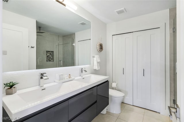 bathroom featuring vanity, tile patterned floors, toilet, and walk in shower