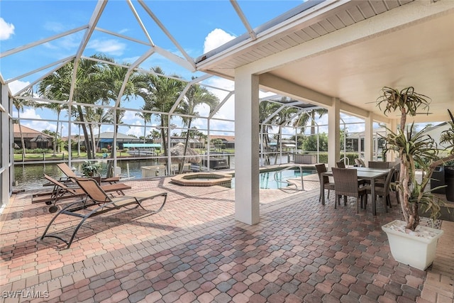 view of patio / terrace with a water view, a lanai, and a pool with hot tub