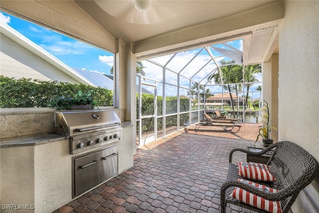 view of patio with area for grilling and a water view