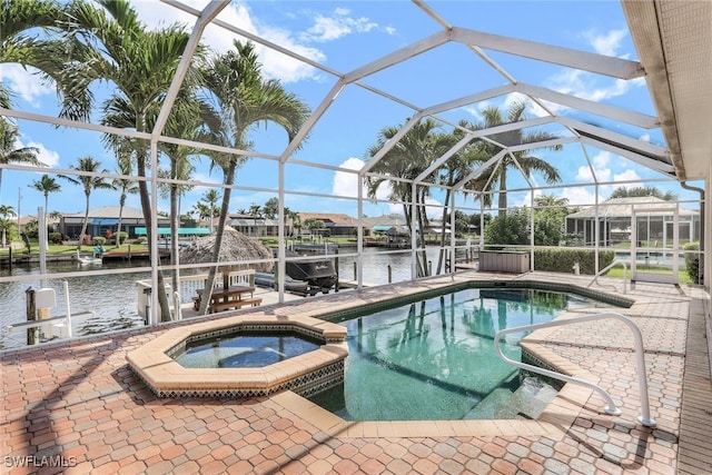 view of swimming pool featuring a patio, a water view, glass enclosure, and an in ground hot tub