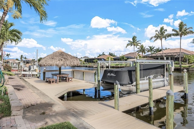 view of dock with a gazebo and a water view