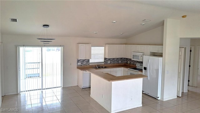 kitchen featuring white cabinetry, backsplash, white appliances, and hanging light fixtures