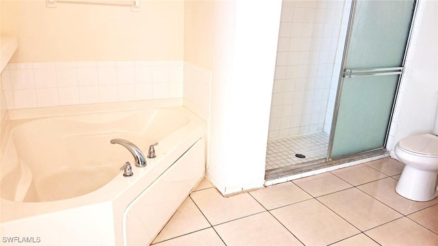 bathroom featuring toilet, separate shower and tub, and tile patterned flooring