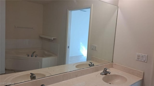 bathroom with vanity and a tub