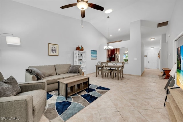 tiled living room featuring ceiling fan with notable chandelier and high vaulted ceiling