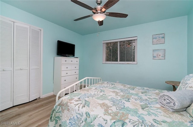 bedroom featuring light hardwood / wood-style flooring, a closet, and ceiling fan