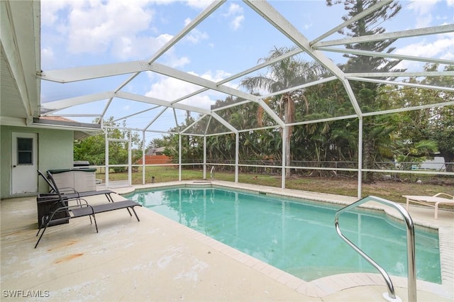 view of swimming pool with a lanai and a patio area