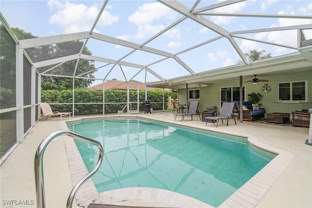 view of pool with a patio area, an outdoor hangout area, ceiling fan, and glass enclosure