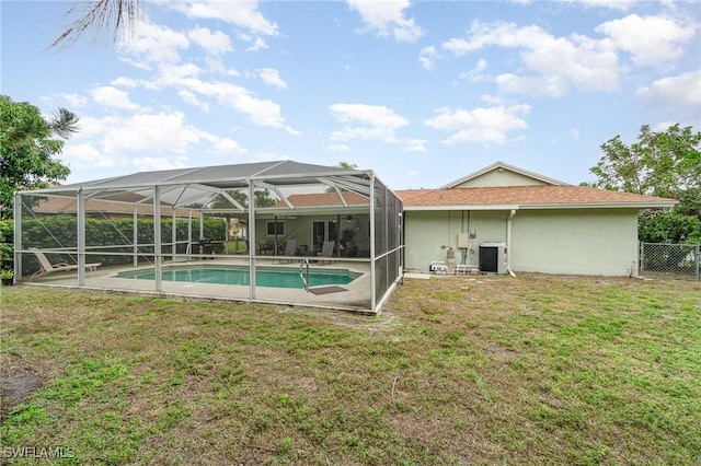 view of pool featuring a lanai, central AC unit, a patio, and a lawn