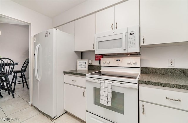 kitchen featuring light tile patterned flooring, white appliances, and white cabinets