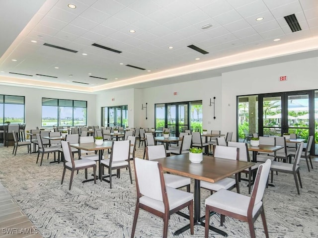 dining room featuring french doors and a tray ceiling