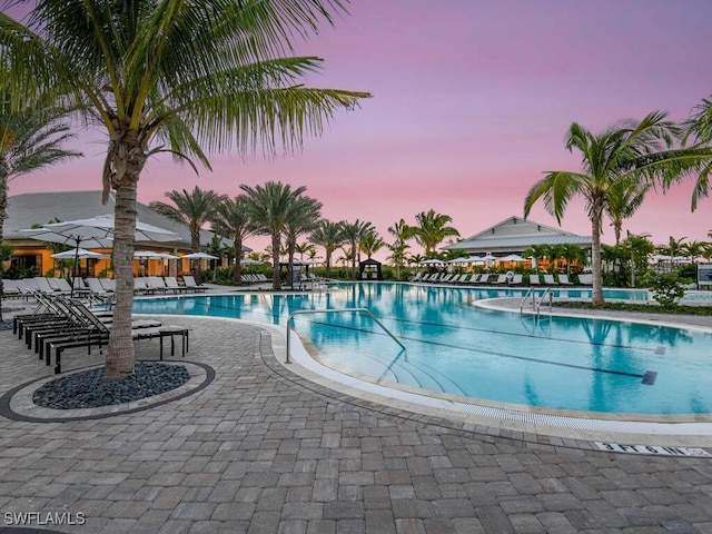 pool at dusk featuring a gazebo