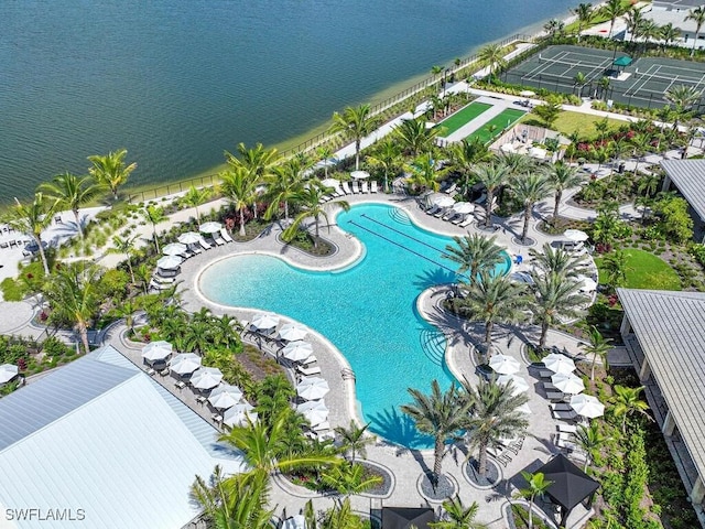 view of swimming pool featuring a patio and a water view