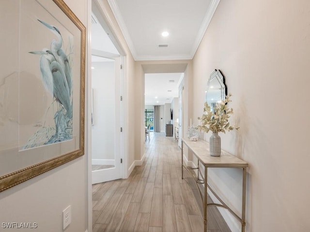 corridor with crown molding and light hardwood / wood-style floors