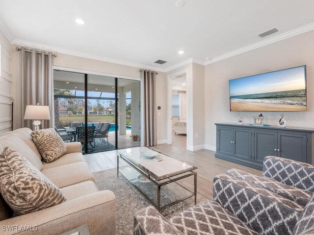 living room featuring crown molding and light hardwood / wood-style flooring