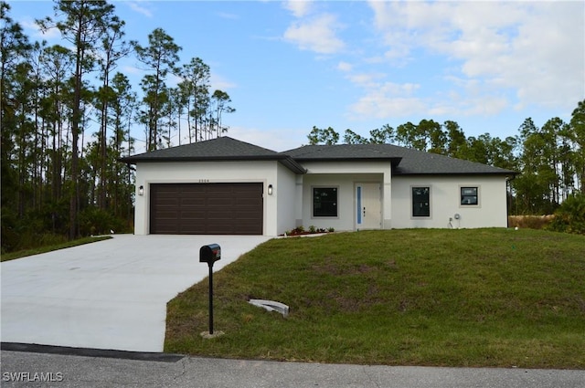 view of front of property with a garage and a front lawn